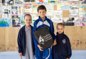 Photo of Volodymyr with his two sisters following a school presentation at Regina Coeli Catholic Primary School Beverly Hills