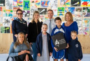 A photo of Volodymyr, his family, Regina Coeli Catholic Primary School Principal, as well as CEF and SCS team members